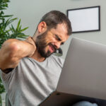 man-experiencing-neck-pain-while-working-from-home-laptop-1.jpg